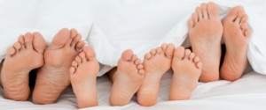 Family on the bed  at home with their feet showing